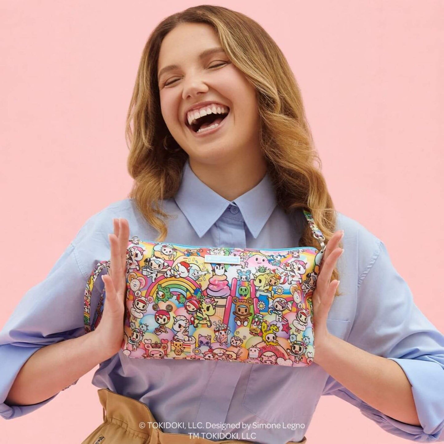 Woman holding tokidoki Be Quick Clutch - 20th Anniversary Celebration