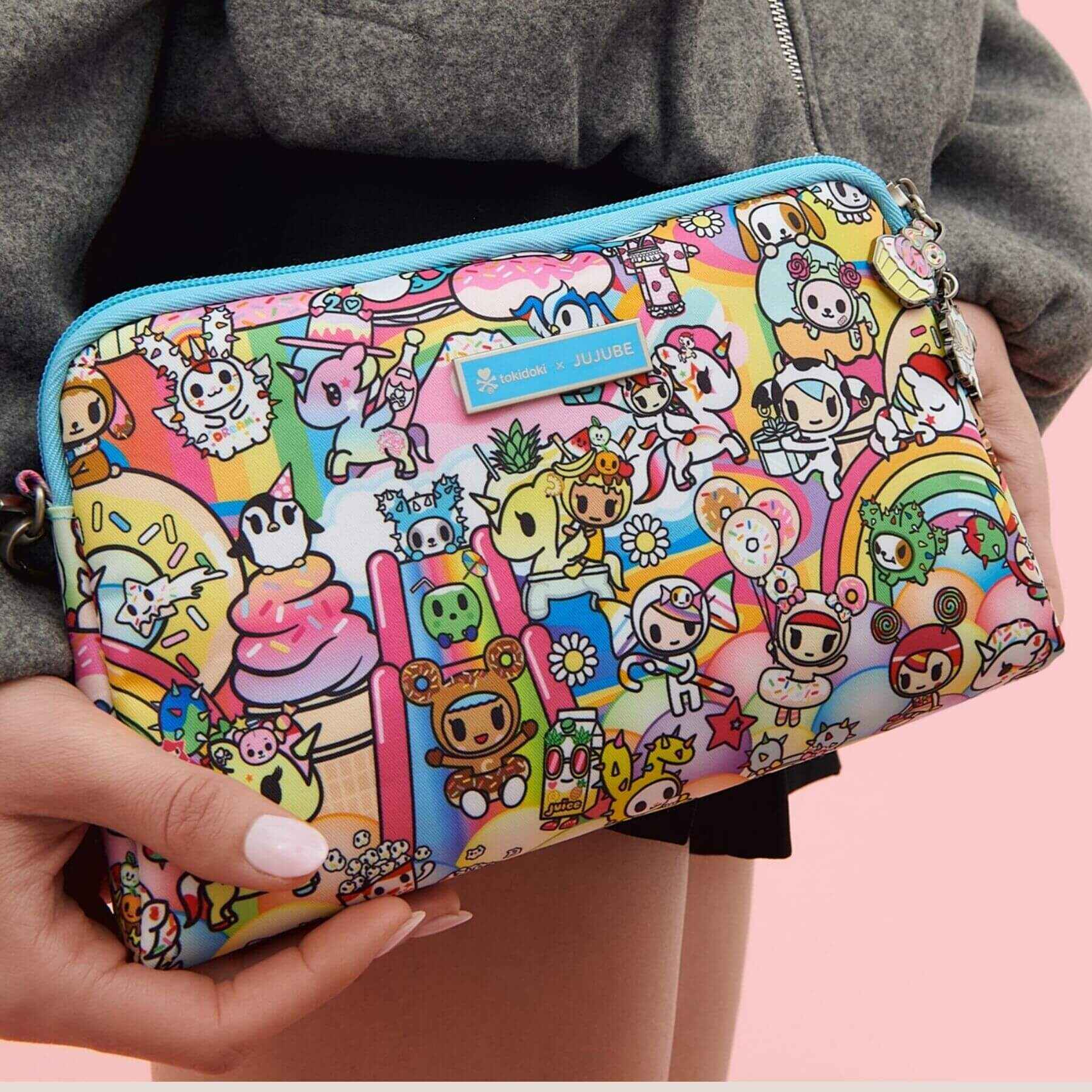 tokidoki Be Set Pouch held by a person against a pink background