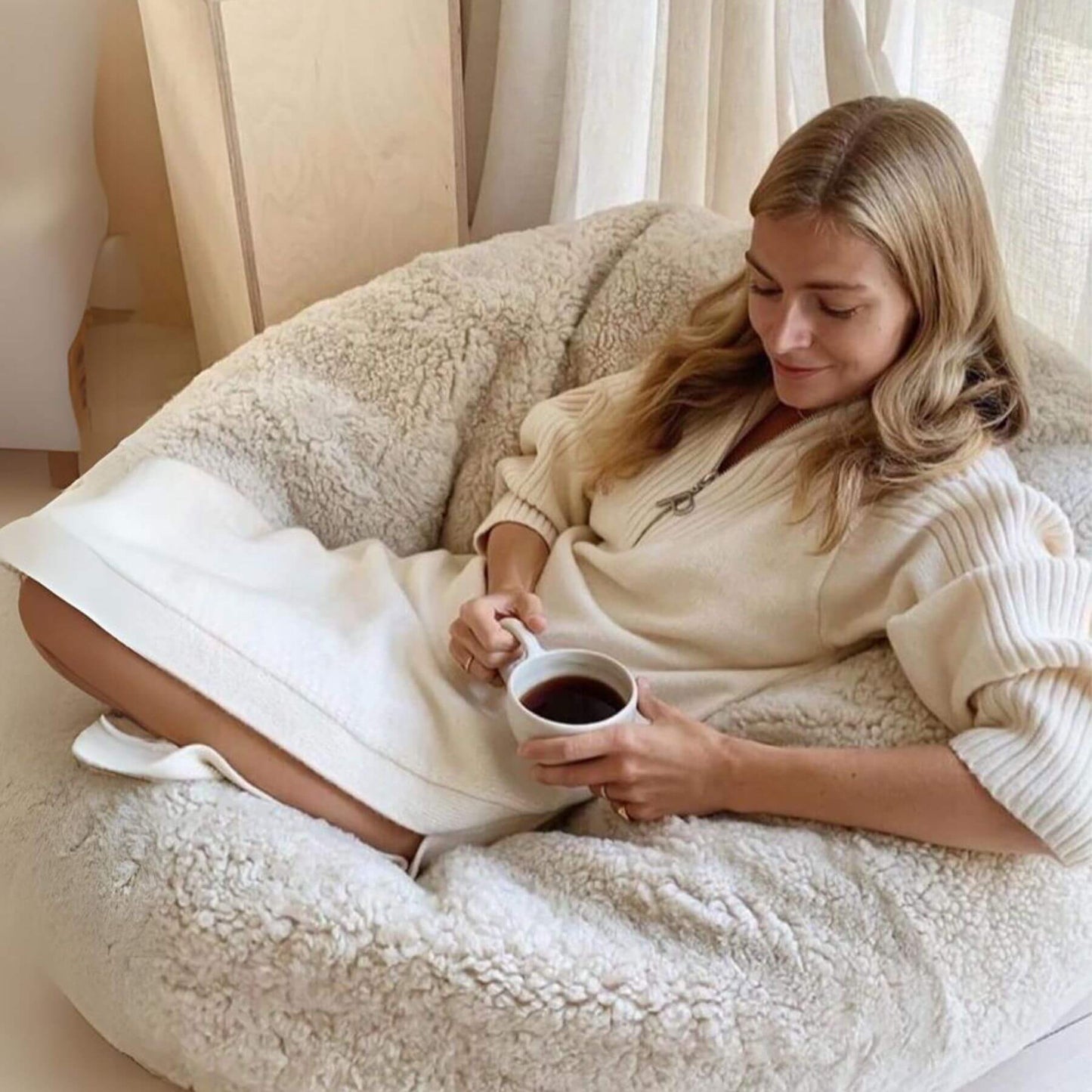 Woman Sitting on Bean Bag Chair, New Zealand Sheepskin, SW Curly, Ivory