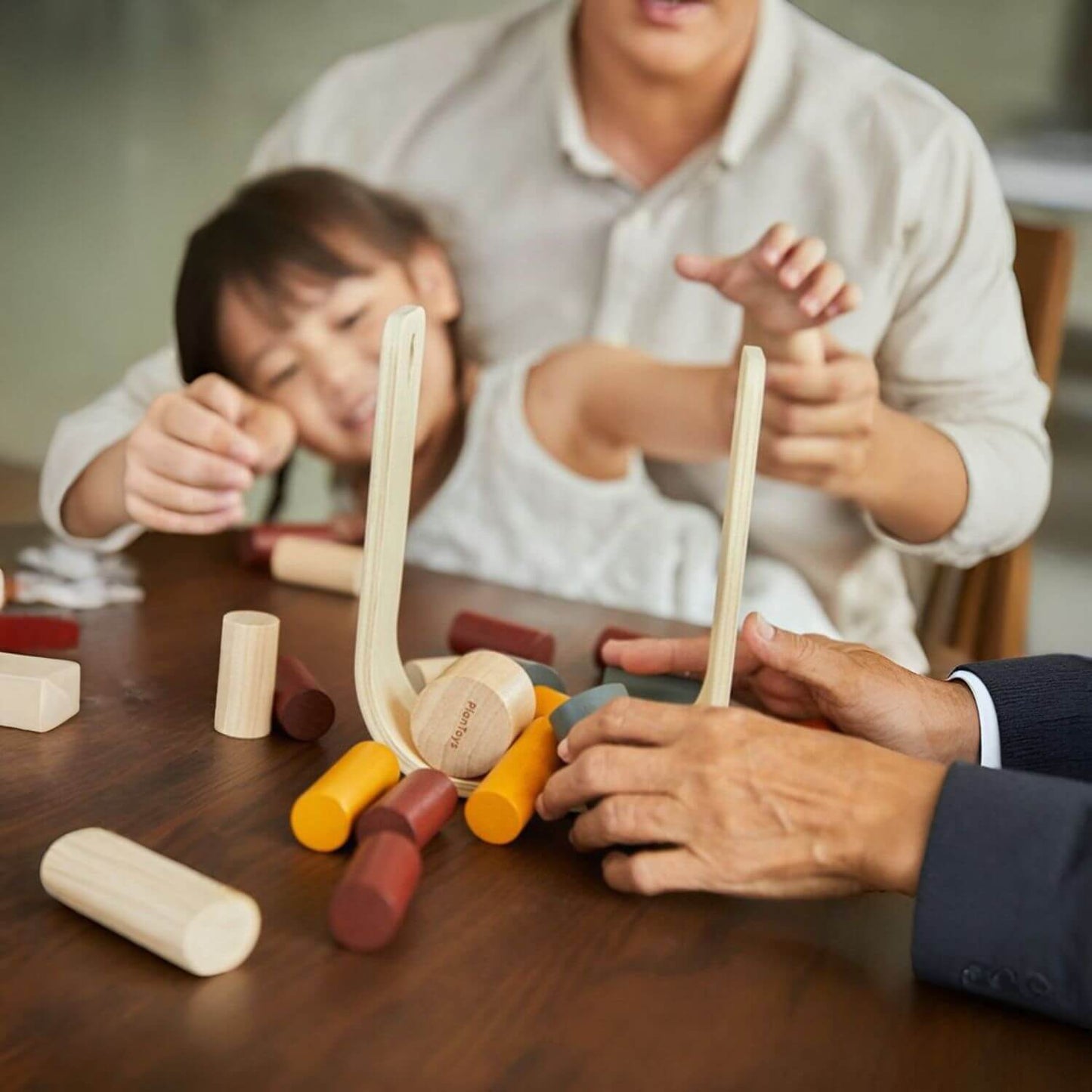 Family Playing PlanToys Beaver Tumble