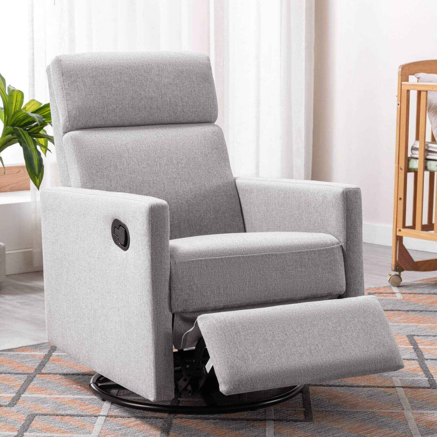Gray recliner chair in a living room setting with a plant and wooden furniture.