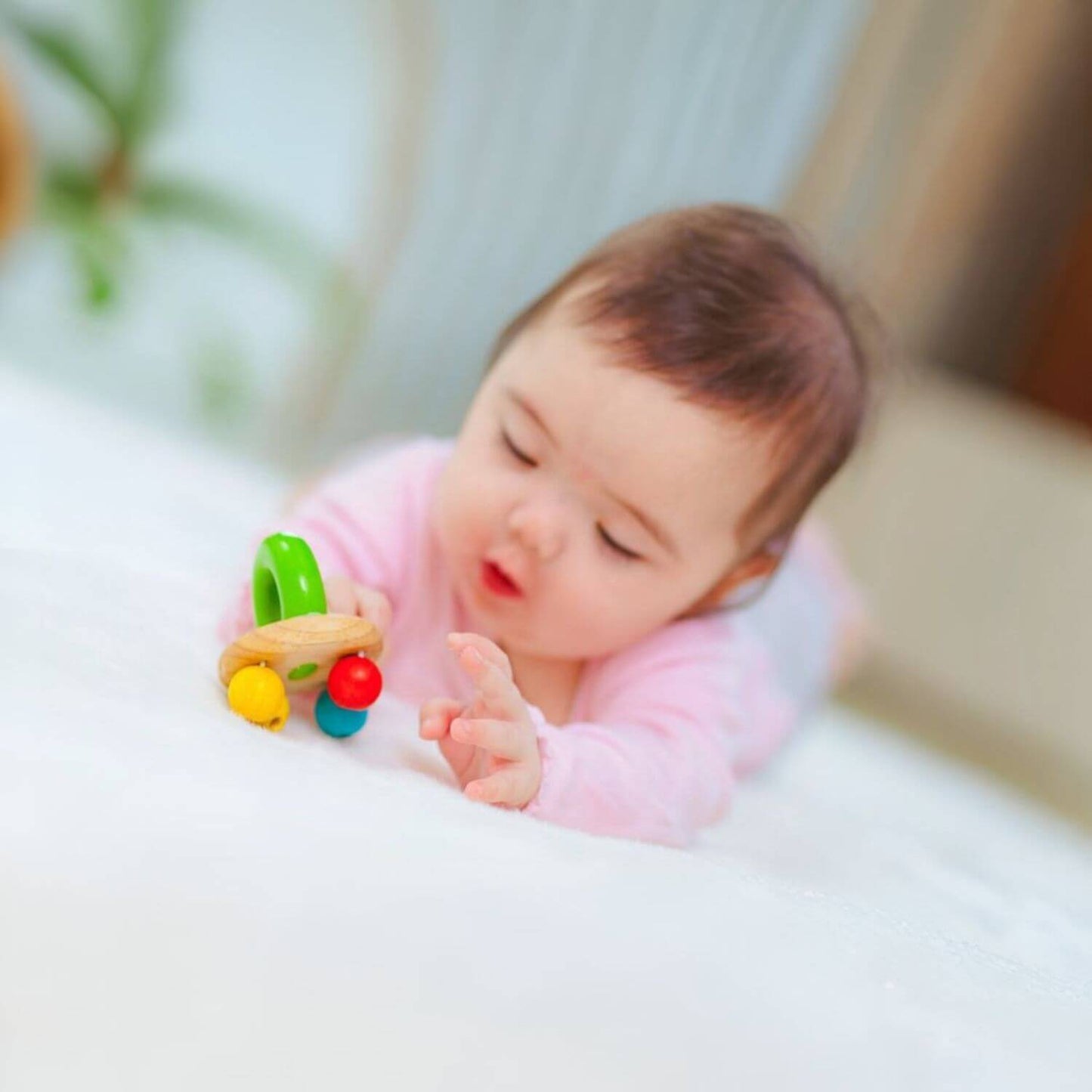 Baby Playing PlanToys Bell Rattle - Bright