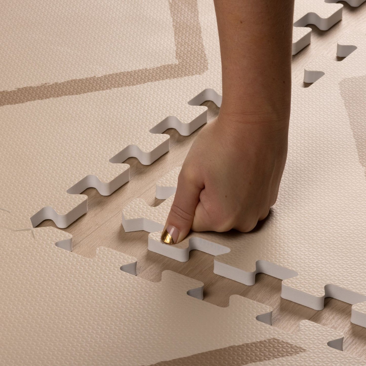 Hand placing on Eeveve Beni Autumn Gold Play Mat