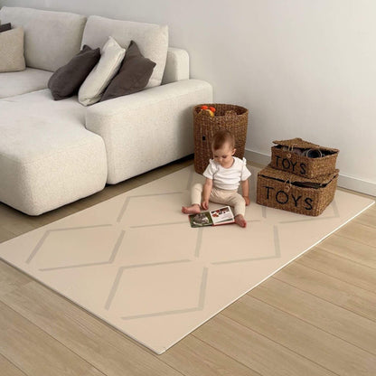 Child playing on Eeveve Beni Cashmere Play Mat in a living room with a sofa and toy storage baskets.