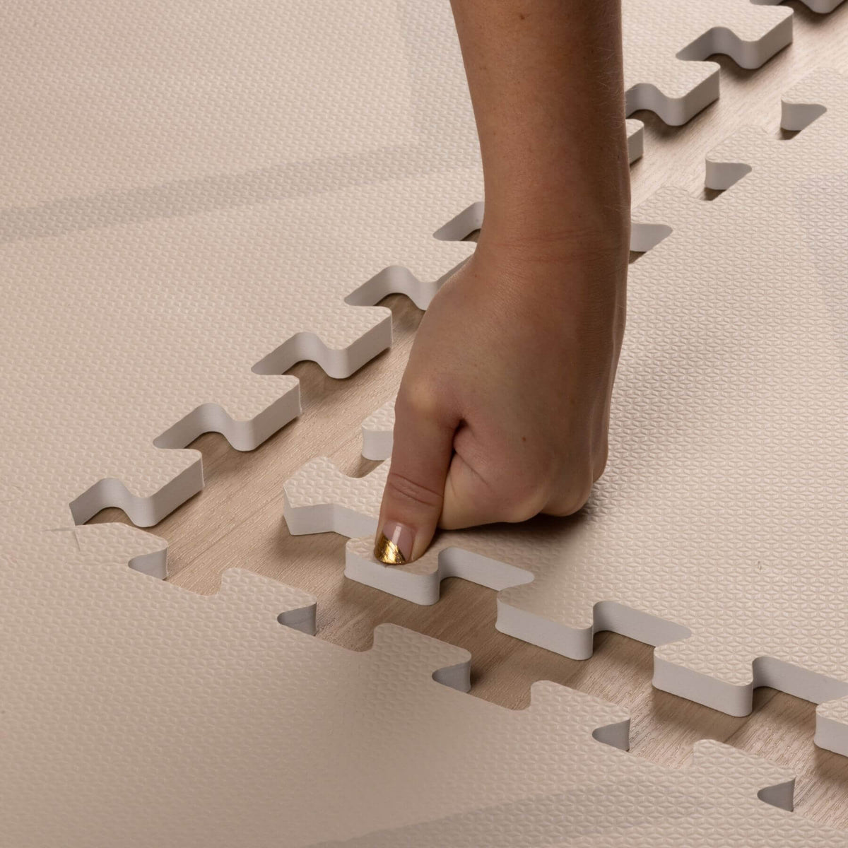 Hand placing on Eeveve Beni Cashmere Play Mat