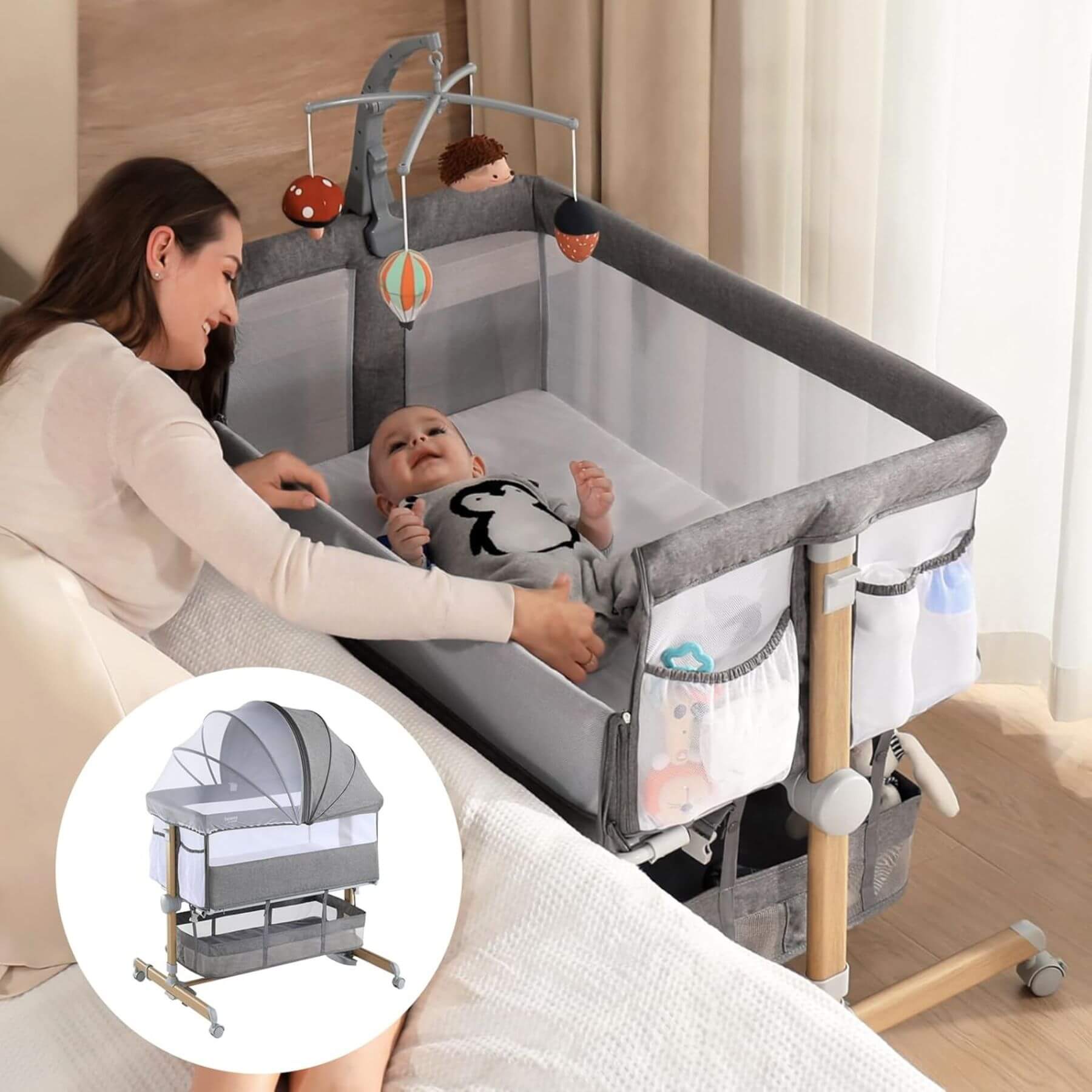 Baby in Besrey 3-in-1 Newborn Bedside Crib with Mobile Toy Hanger Next to Mom's Bed