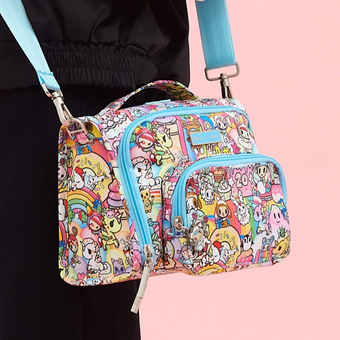 tokidoki The Bestie Small Messenger Handbag held by a person on a pink background