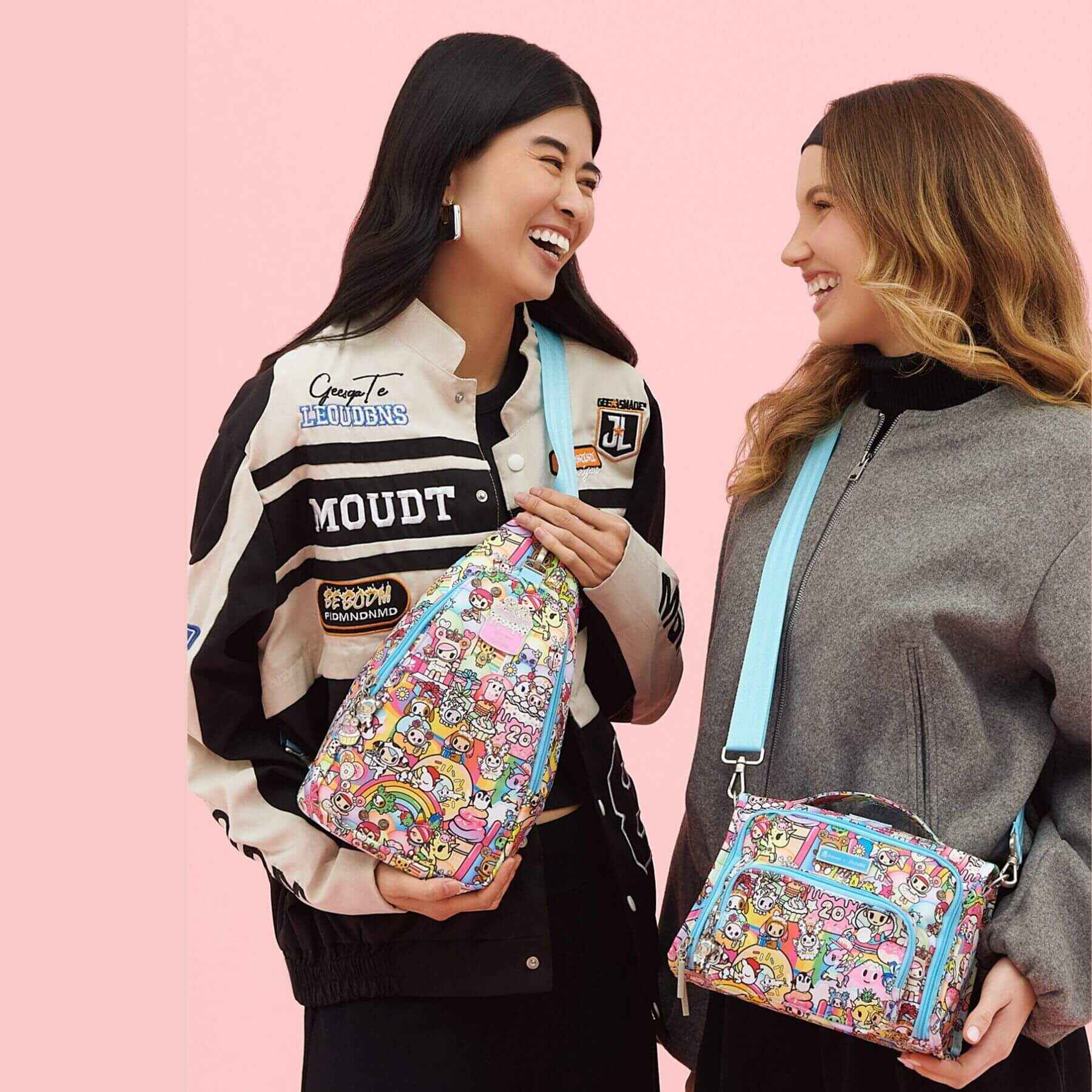 Two women holding tokidoki The Bestie Small Messenger Handbags