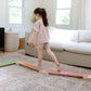 Child standing on Bunny Hopkins Balance Beam in a living room