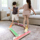 Two children playing with Bunny Hopkins Balance Beam in a living room.