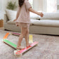 Child standing on Bunny Hopkins Balance Beam in a living room.