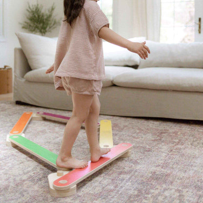 Child standing on Bunny Hopkins Balance Beam in a living room.