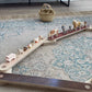 Bunny Hopkins Balance Beam with animal figures on a patterned rug