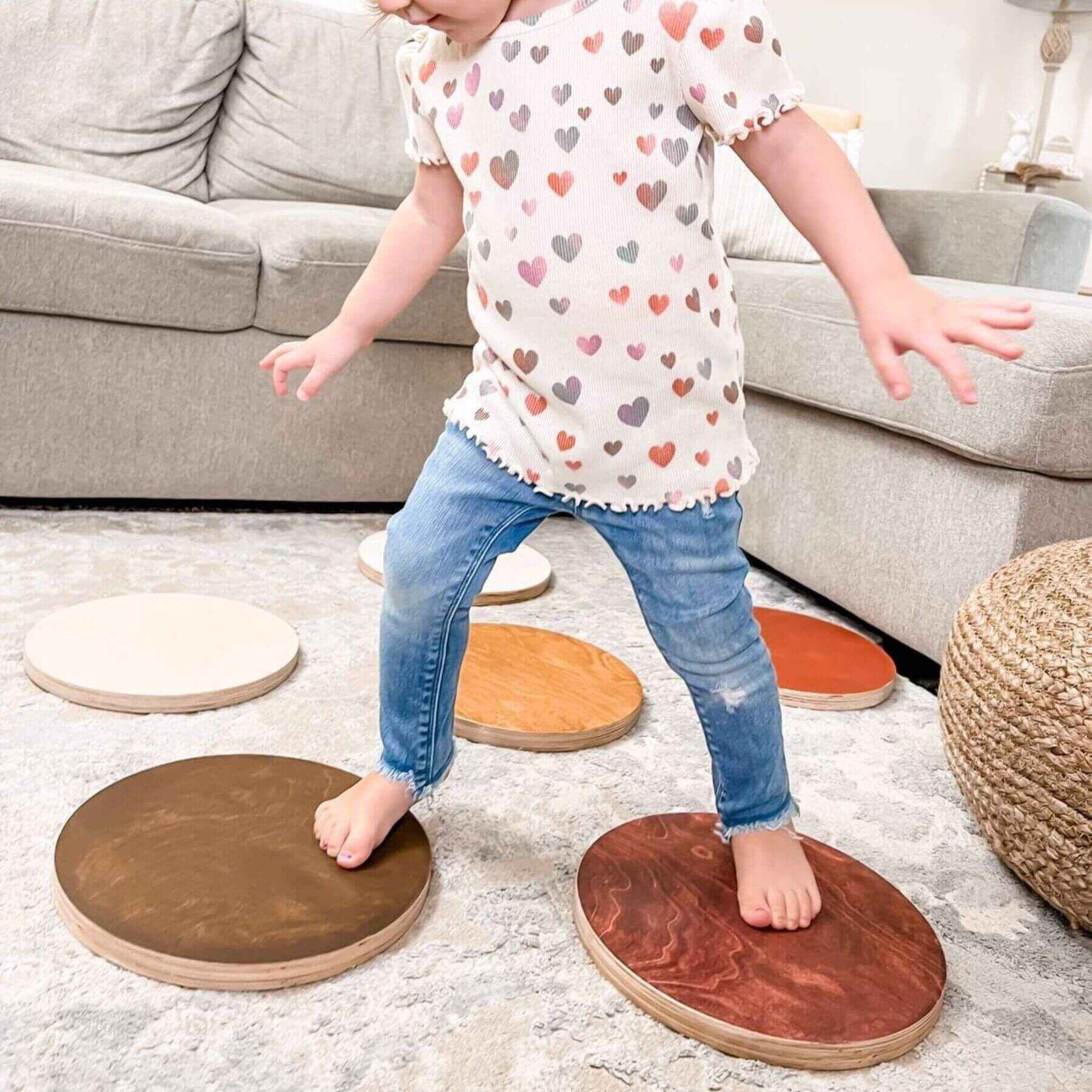 Child stepping on Bunny Hopkins Stepping Stones in a living room setting