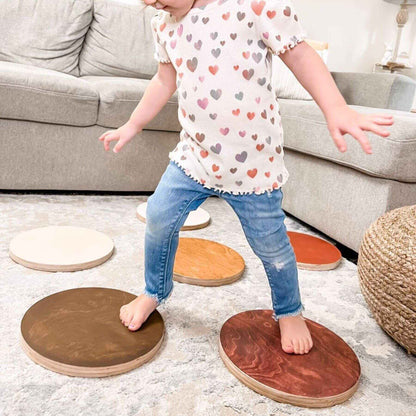 Child stepping on Bunny Hopkins Stepping Stones in a living room setting