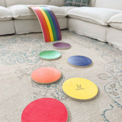 Bunny Hopkins Stepping Stones on a textured rug with a rainbow item in the background.