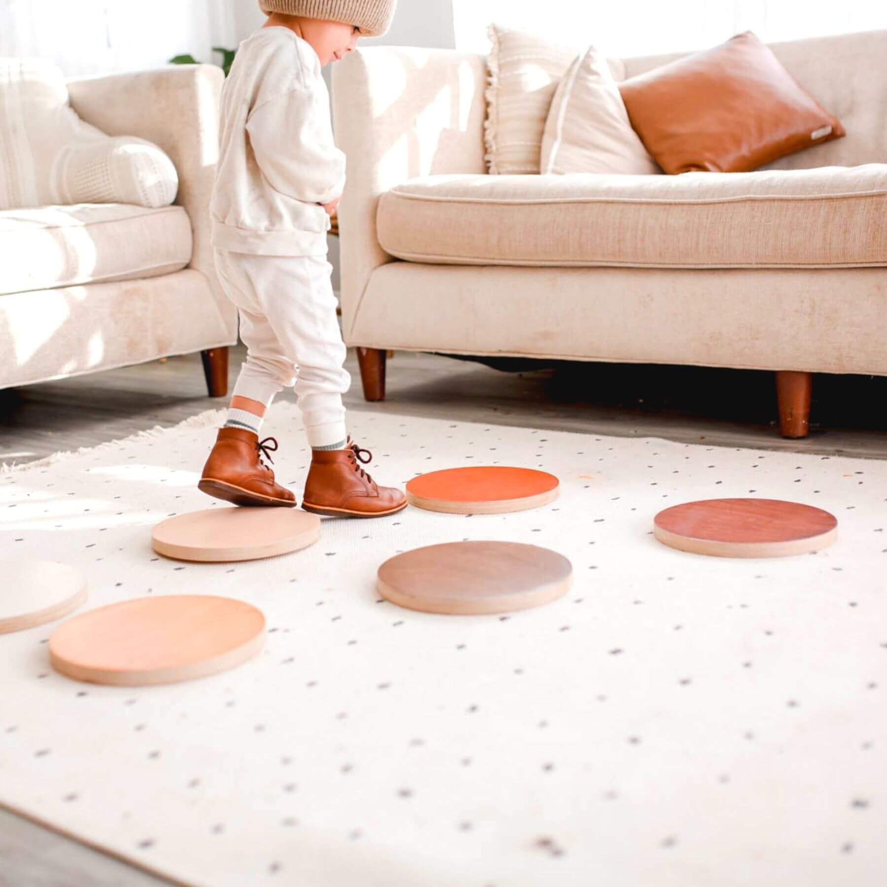 Child playing with Bunny Hopkins Stepping Stones on a light-colored floor.