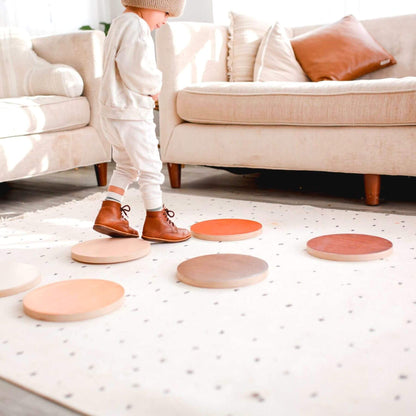Child playing with Bunny Hopkins Stepping Stones on a light-colored floor.