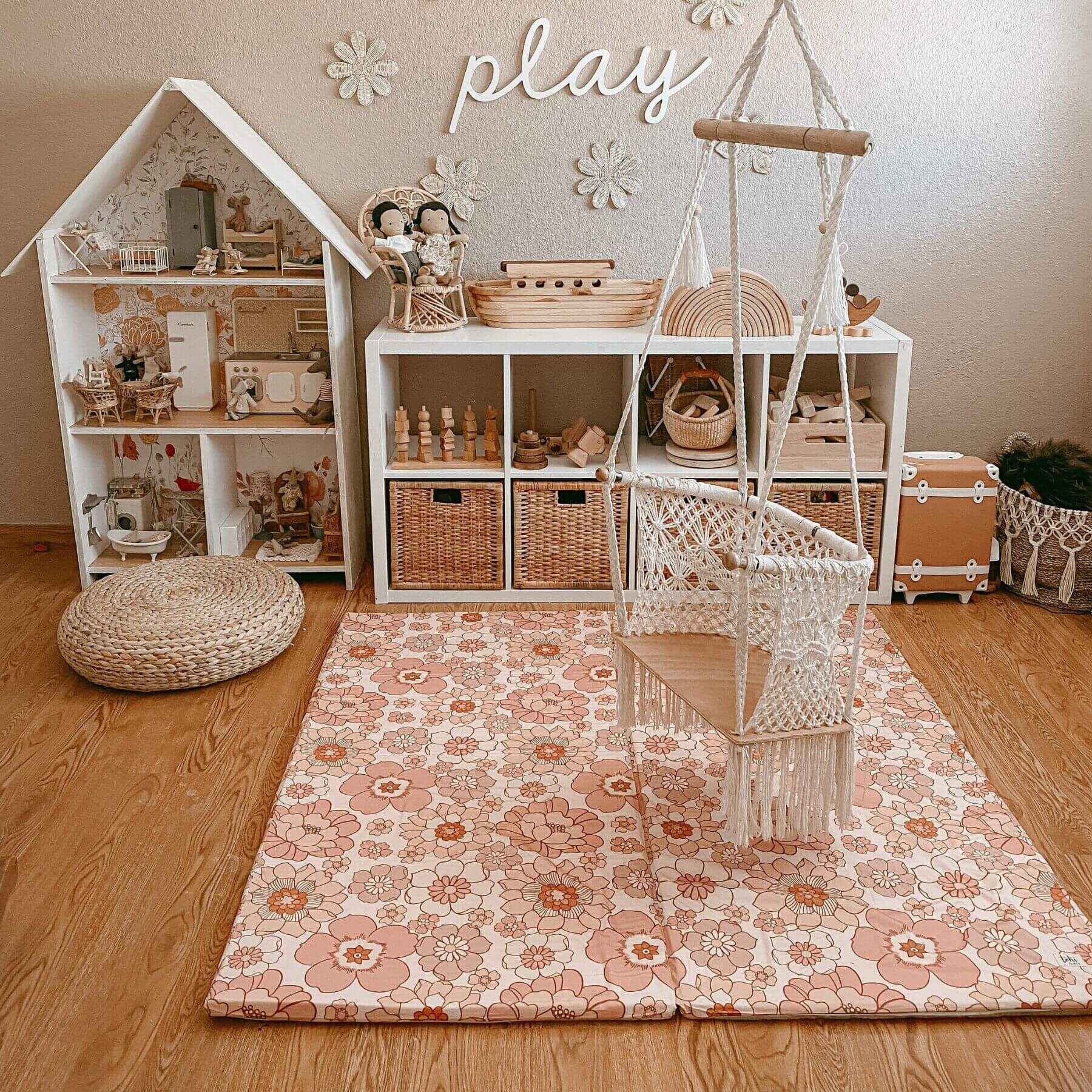 Children's playroom with dollhouse, toys, and Toki Mats Blooms Organic Cotton Mat.