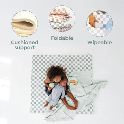 Child sitting on a cushion with features highlighted: cushioned support, foldable, and wipeable.