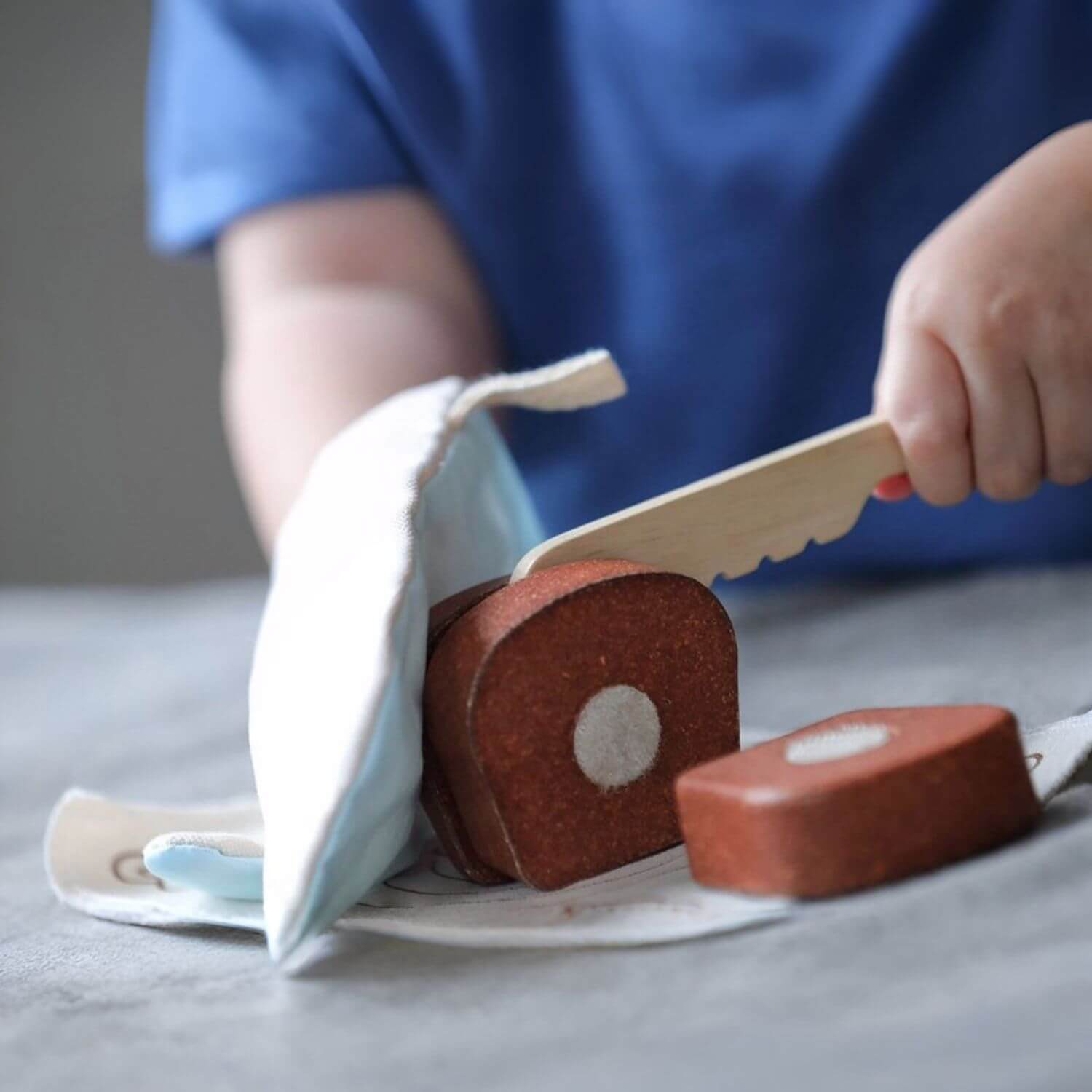 Kid Playing PlanToys Bread Loaf Set