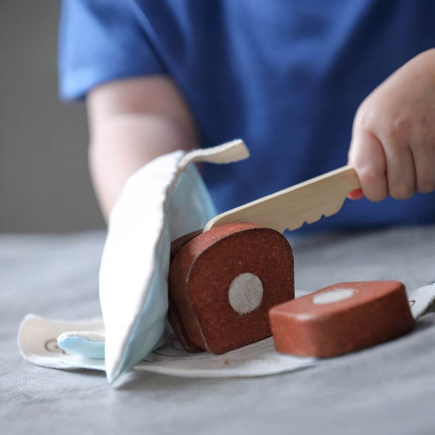 Kid Playing PlanToys Bread Loaf Set