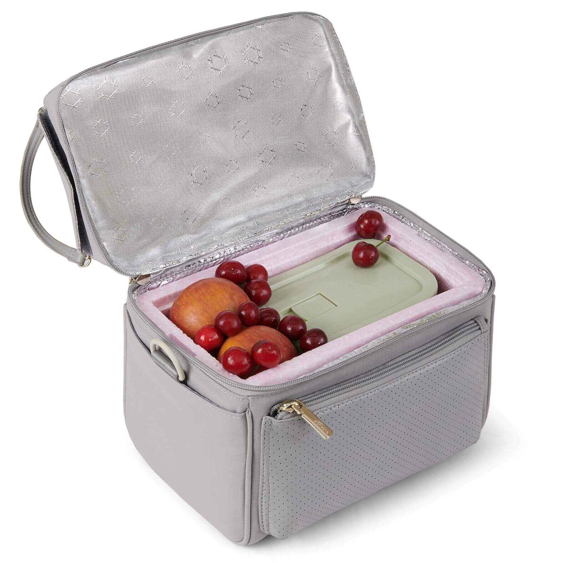 Gray insulated food container with fruits and a phone on a white background