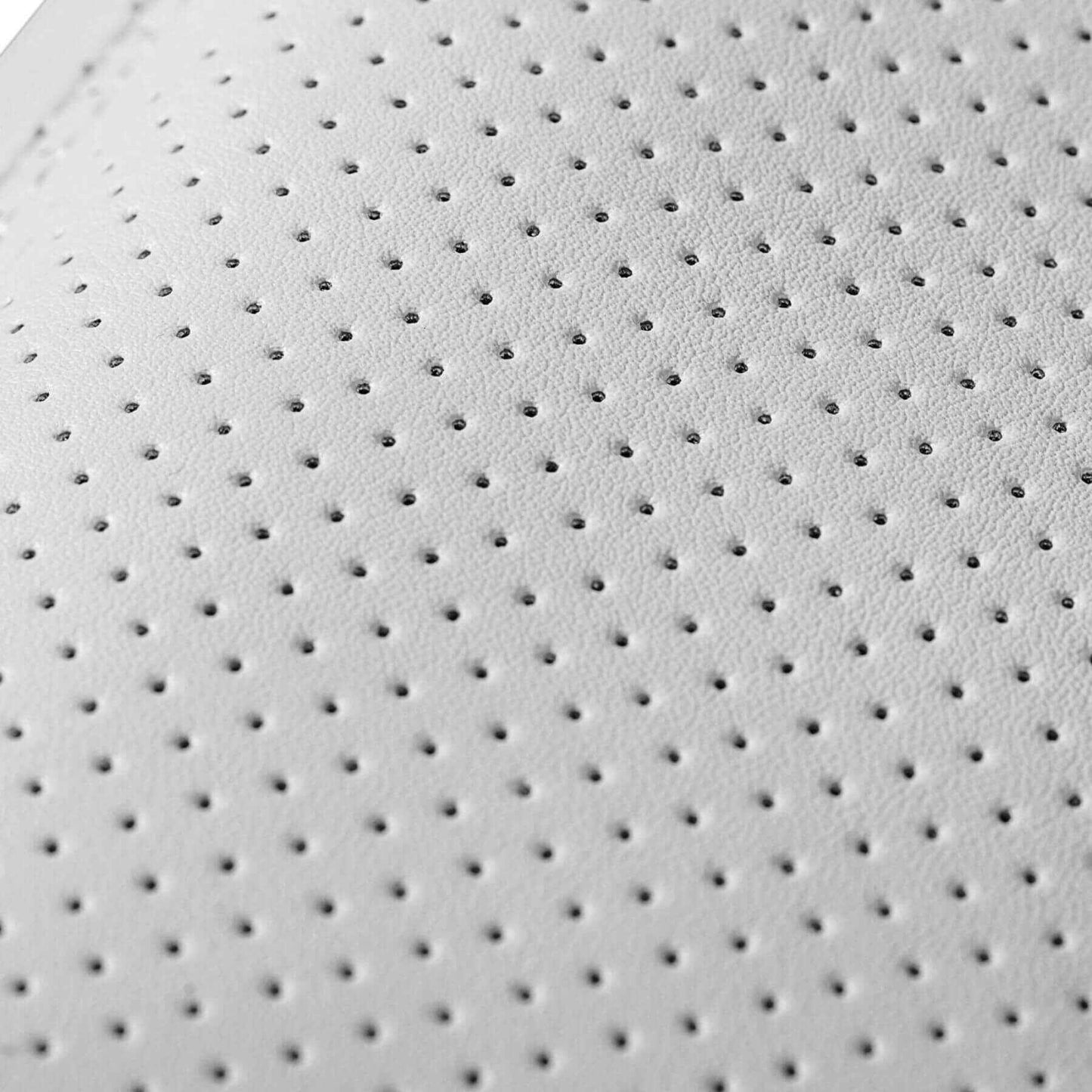 Close-up of a textured white surface with small holes