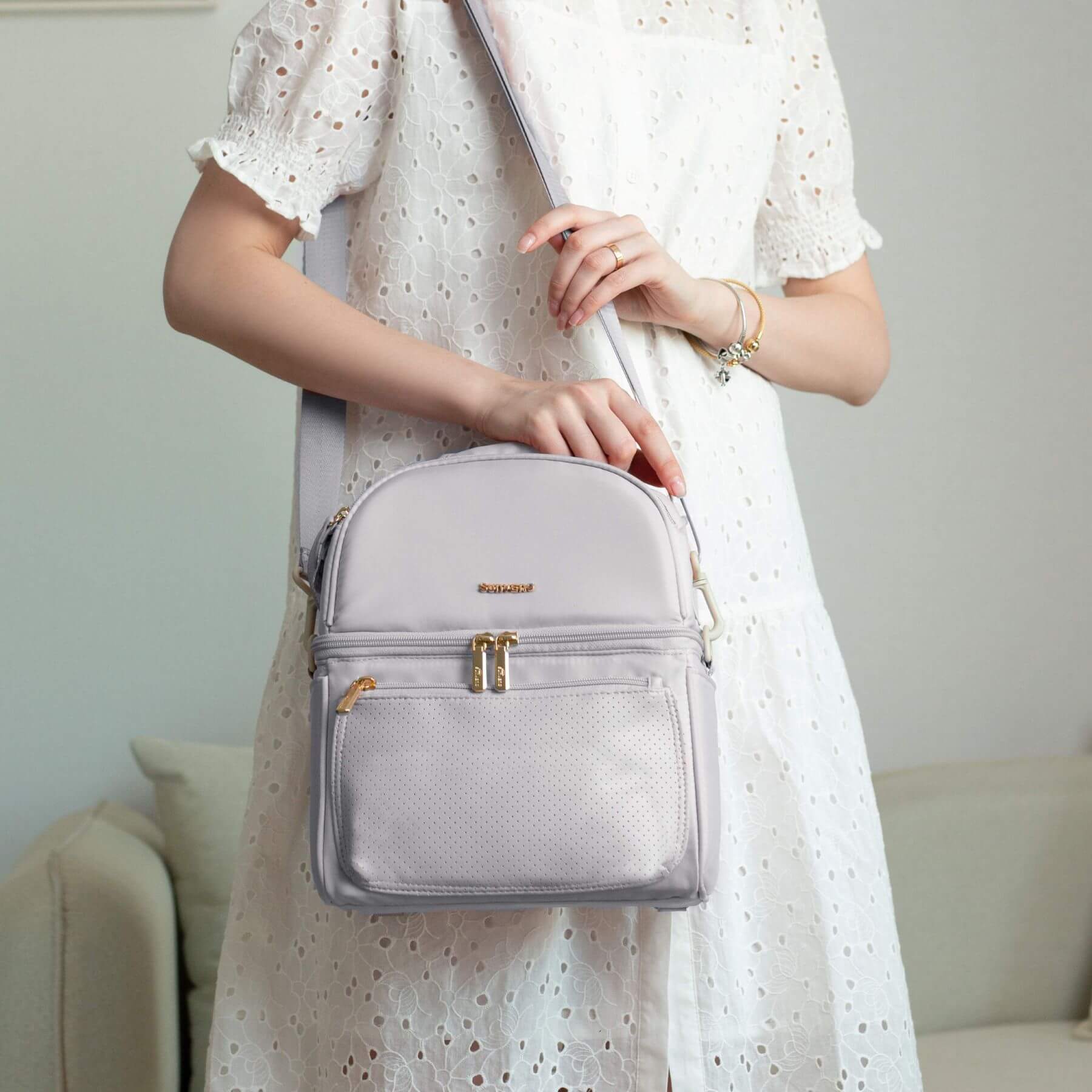 Person holding Sunveno Breastmilk Cooler Bag - Grey with a blurred background