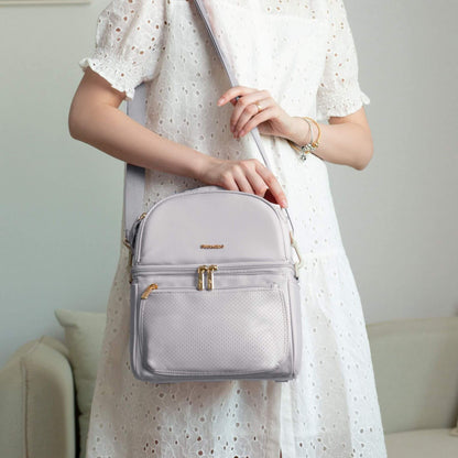 Person holding Sunveno Breastmilk Cooler Bag - Grey with a blurred background