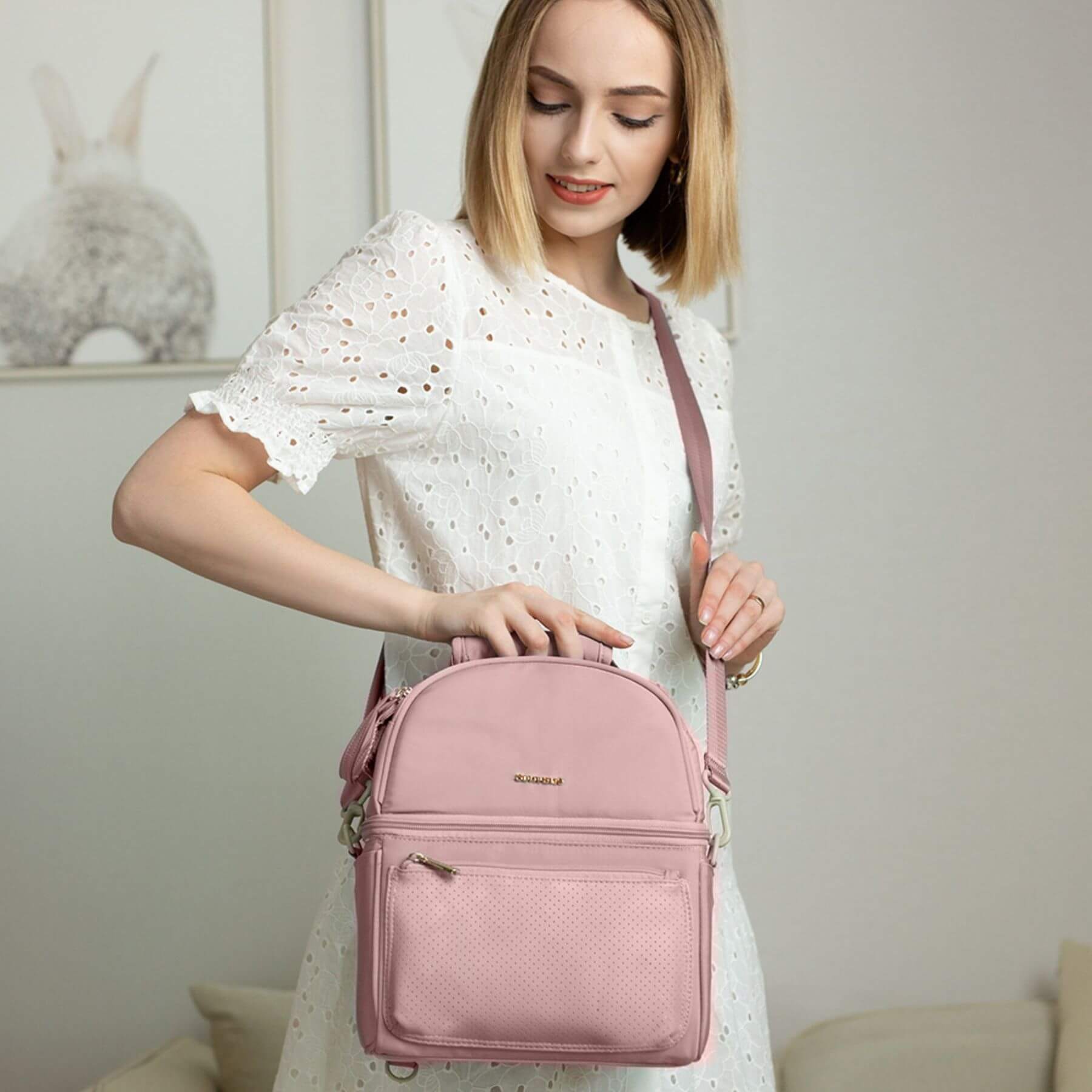 Woman holding Sunveno Breastmilk Cooler Bag - Pink indoors with a neutral background