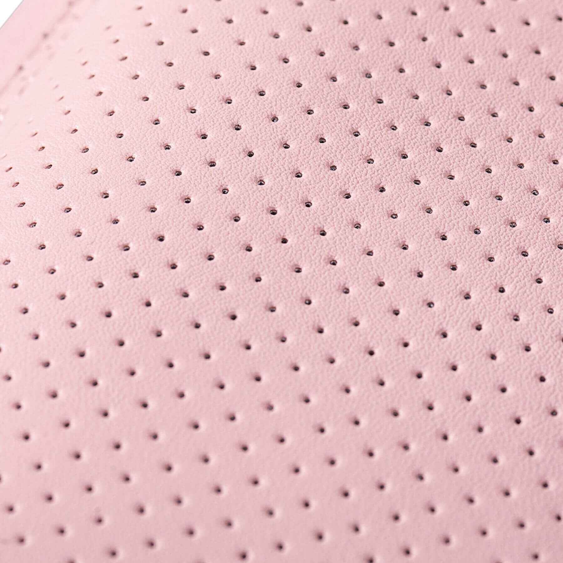 Close-up of pink textured material with small holes