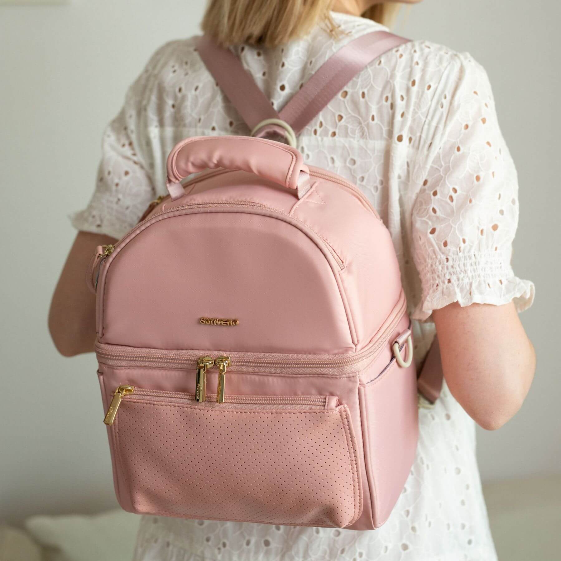 Person wearing Sunveno Breastmilk Cooler Bag - Pink with a blurred background