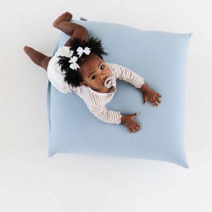 Baby lying on Toki Kids Breeze Bean Bag with white background