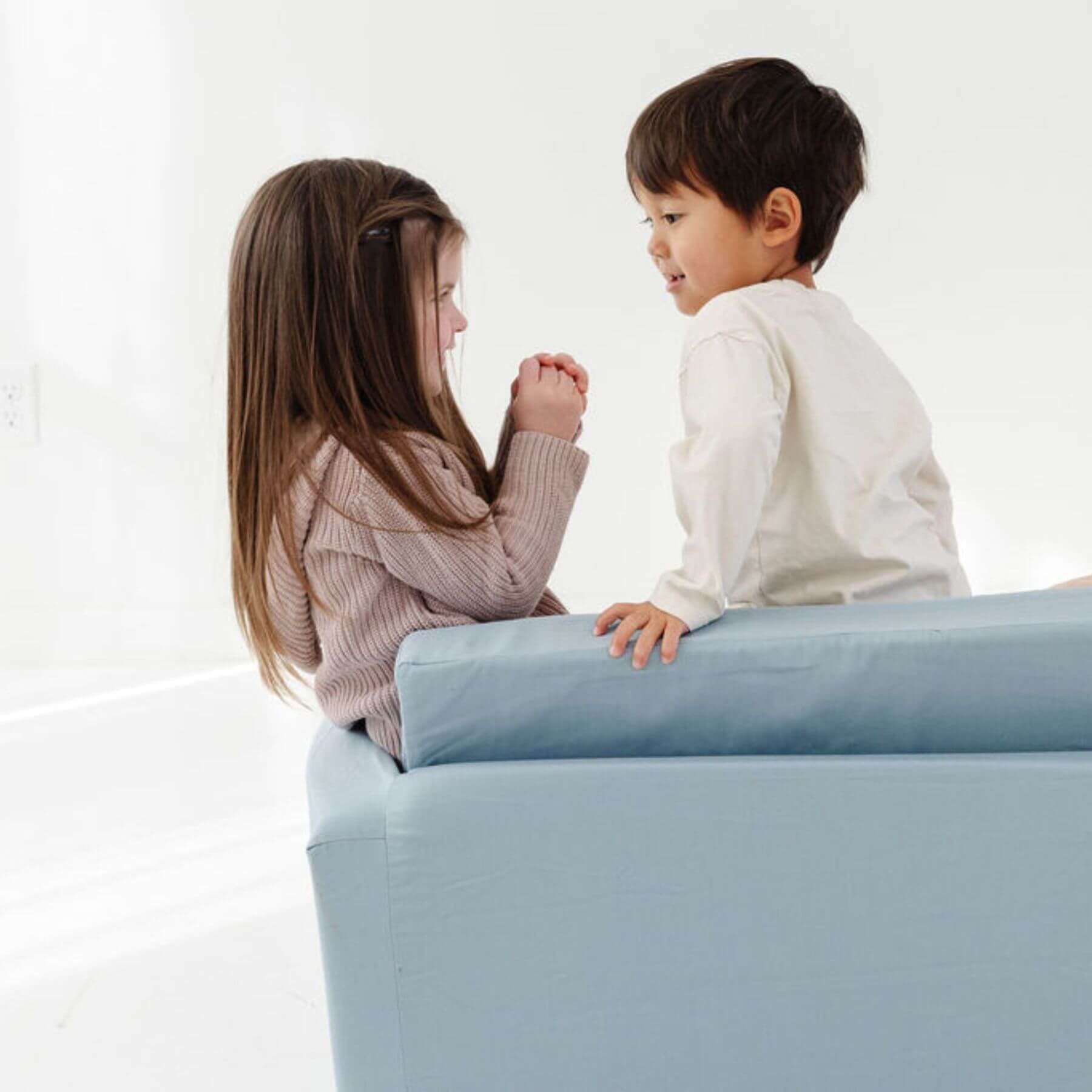 Two children sitting on Toki Kids Breeze Play Couch