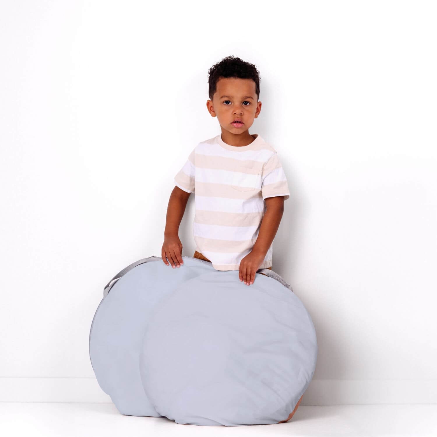 Boy holding folded Toki Kids Breeze Play Tent