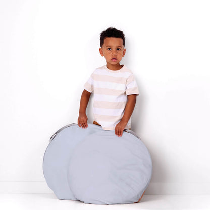 Boy holding folded Toki Kids Breeze Play Tent