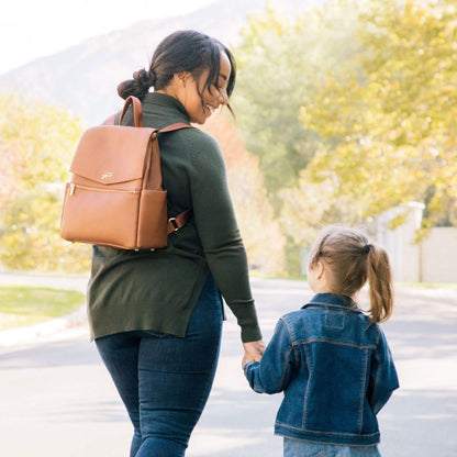 Woman with Butterscotch Mini Classic Bag II and a child holding hands outdoors