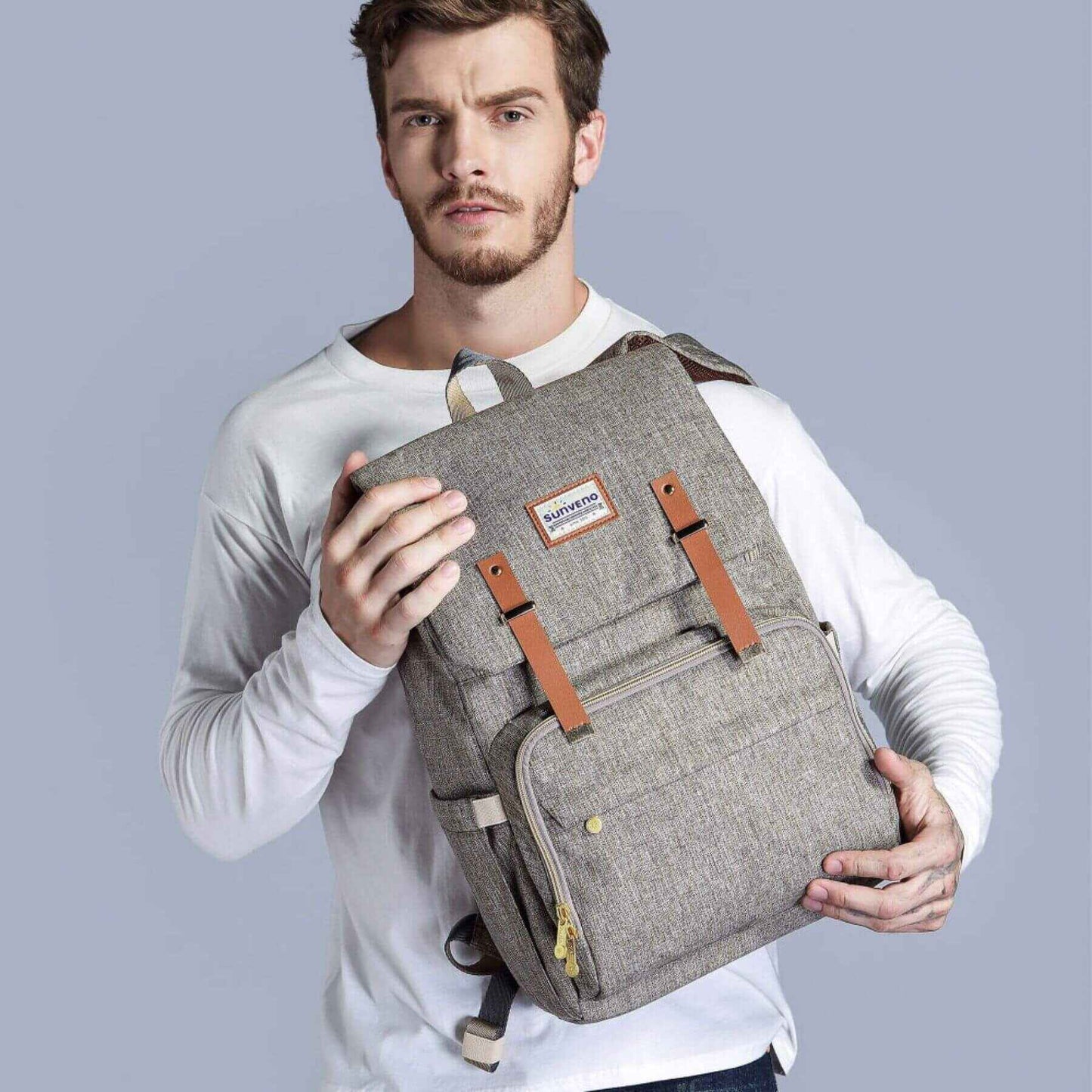 Man holding Sunveno Canvas Diaper Backpack - Brown