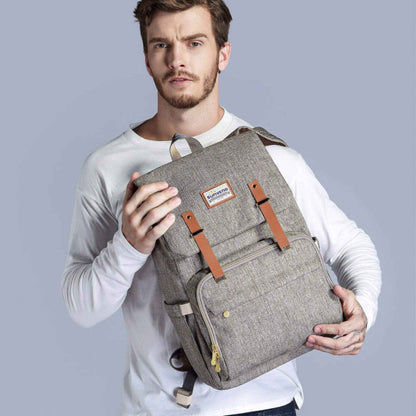 Man holding Sunveno Canvas Diaper Backpack - Brown