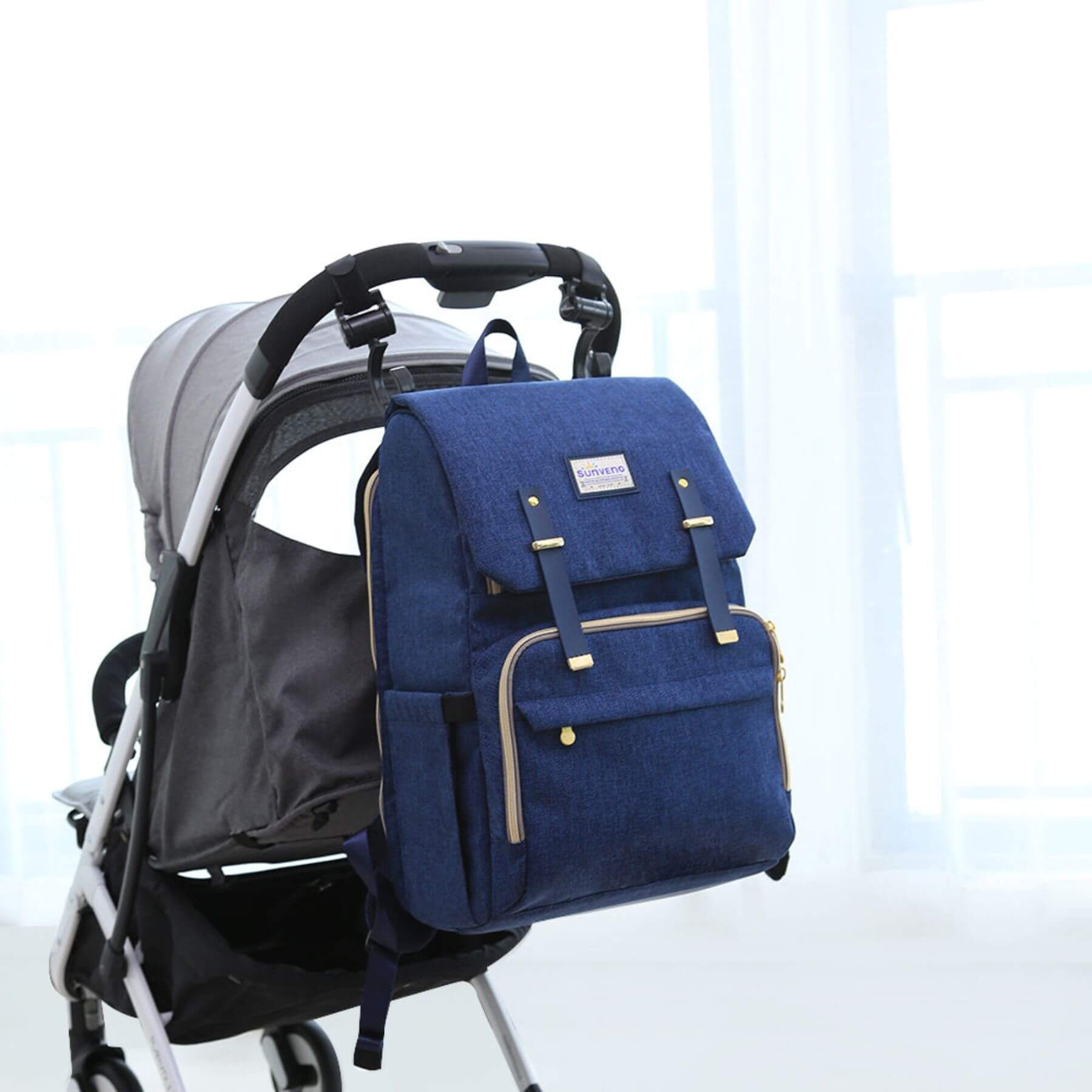 Sunveno Canvas Diaper Backpack - Navy hanging on a stroller