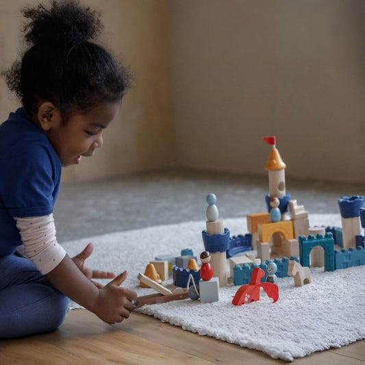 Girl Playing PlanToys Castle Blocks - Orchard