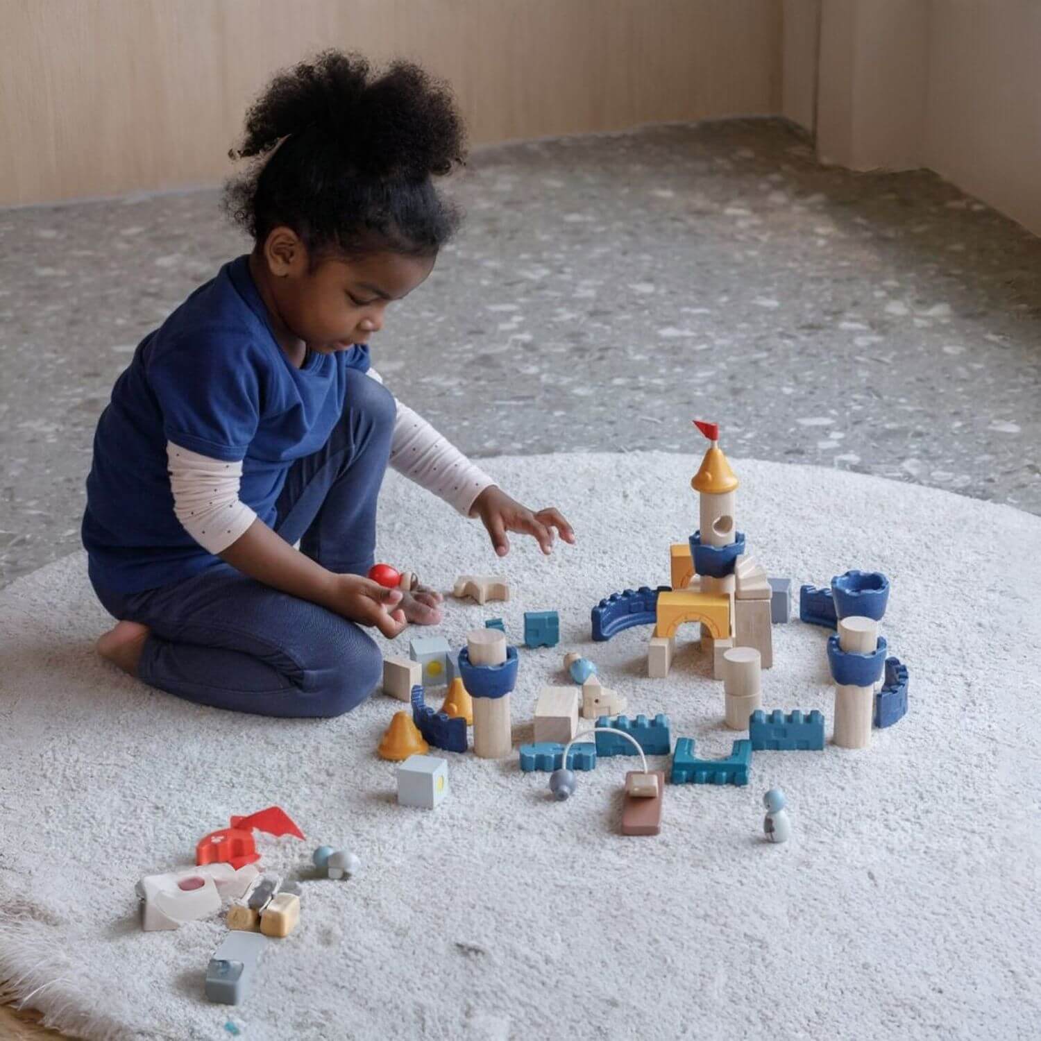 Girl Playing PlanToys Castle Blocks - Orchard