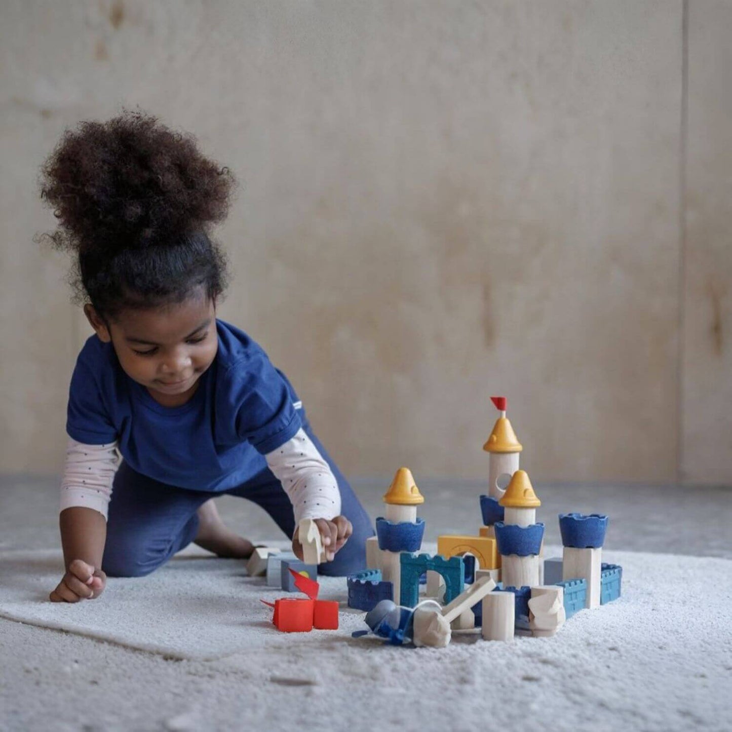 Girl Playing PlanToys Castle Blocks - Orchard