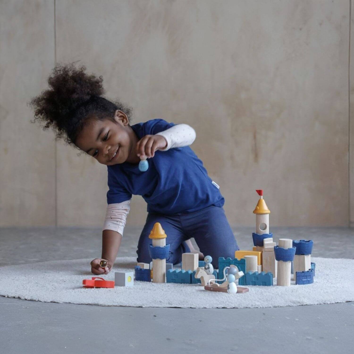 Girl Playing PlanToys Castle Blocks - Orchard