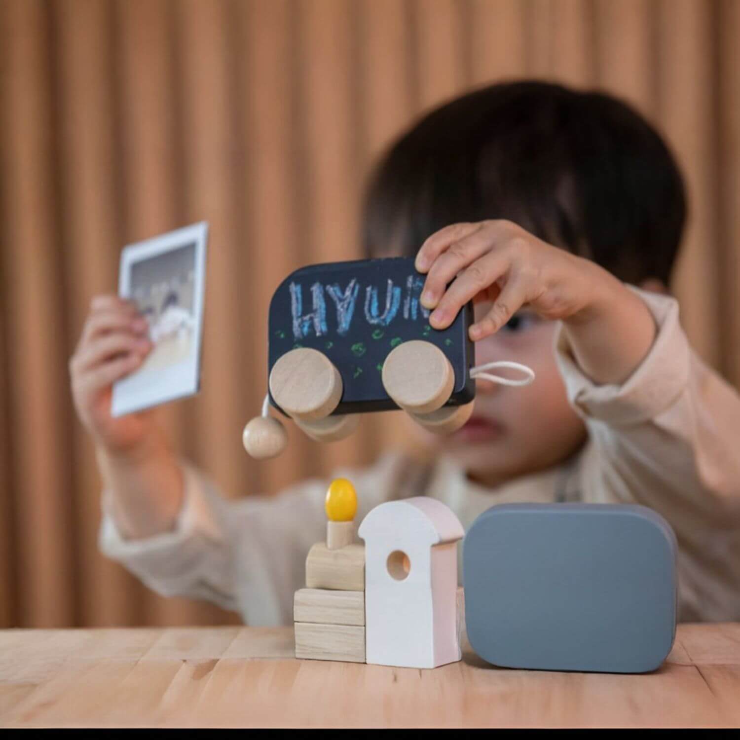 Boy Playing PlanToys Celebration Train