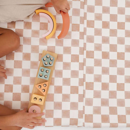 Children playing with colorful wooden shape sorting toys on Toki Kids Checker Toffee Vegan Leather Mat