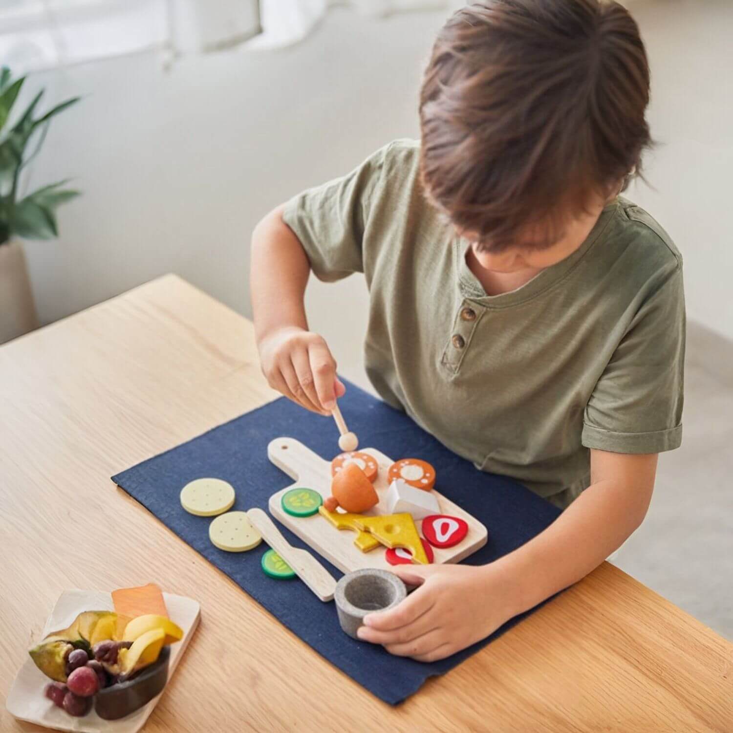 Boy Playing PlanToys Cheese & Charcuterie Board