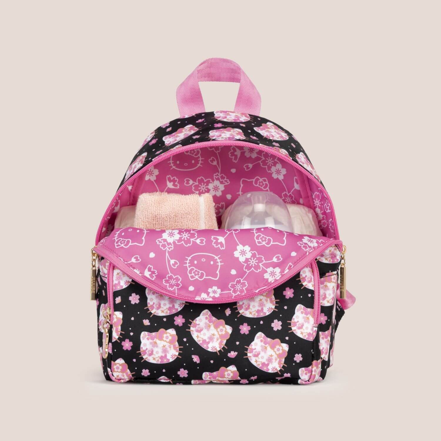 Hello Kitty® × JuJuBe Cherry Blossoms Everyday Mini Diaper Bag Backpack and baby items inside