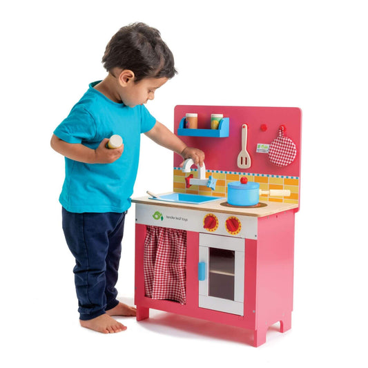 Child playing with Tender Leaf Cherry Pie Kitchen on a white background
